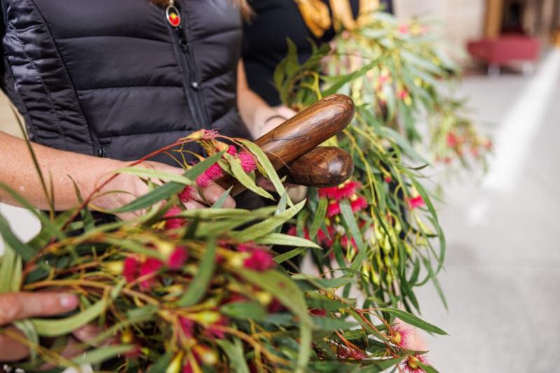Leaves and sticks being held