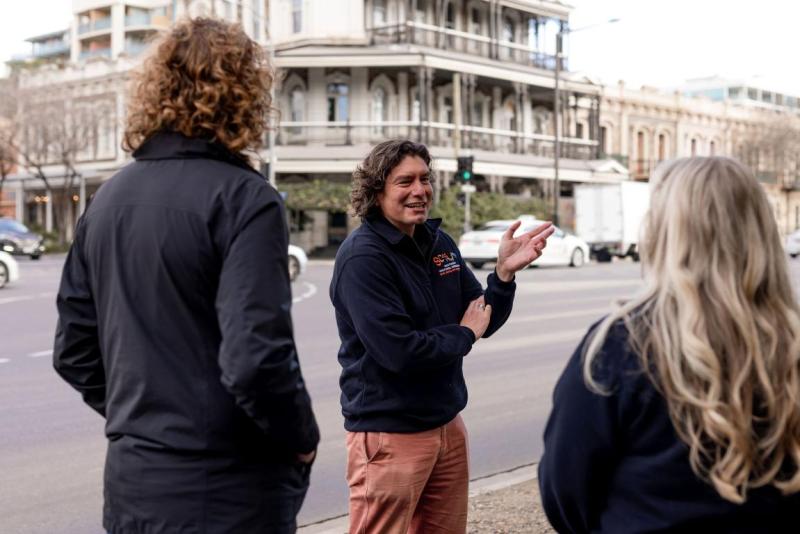 three people stand in a empty street