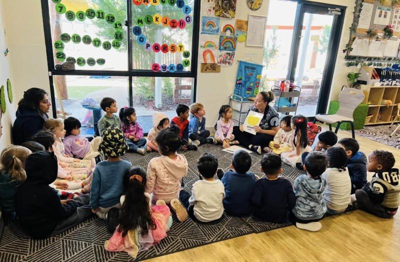 Children sit in a circle in a classroom