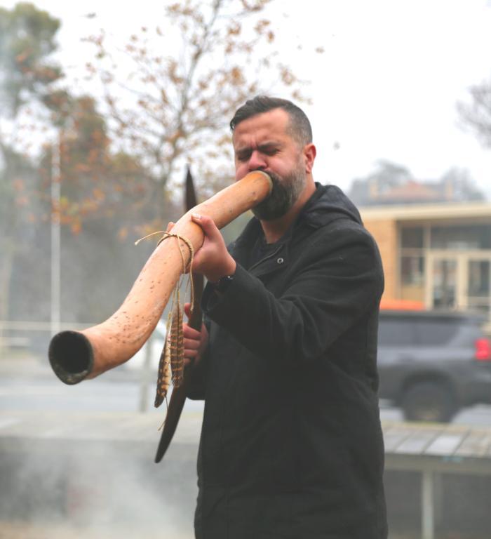 A man plays the didgeridoo