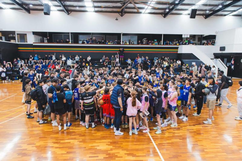 A large crowd on a indoor basketball court