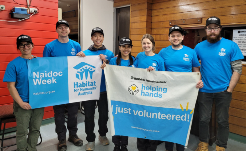 People holding up NAIDOC flags