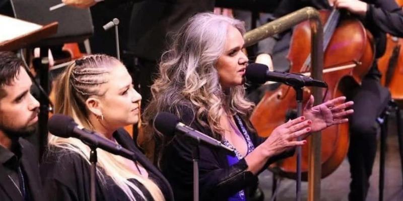 Della at the microphone singing
