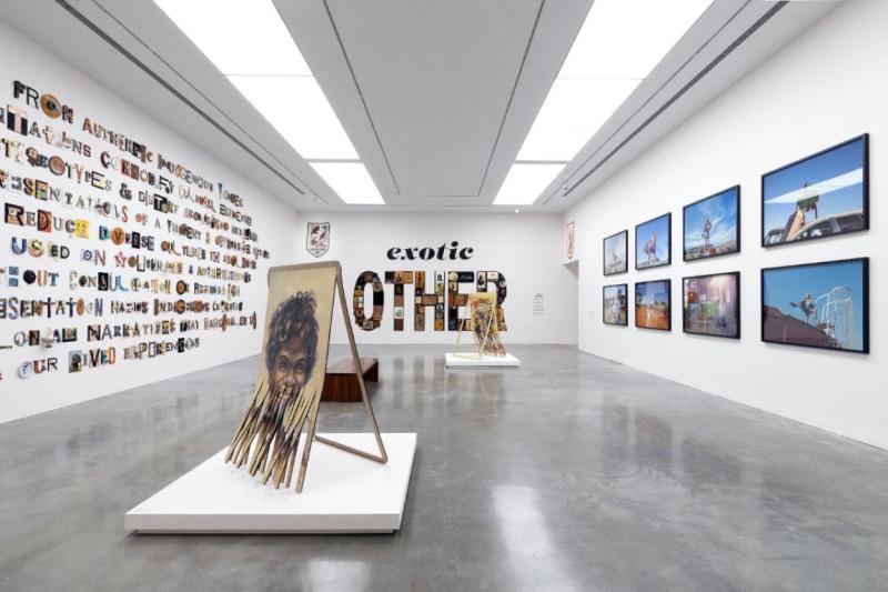 an art gallery with displays on all walls