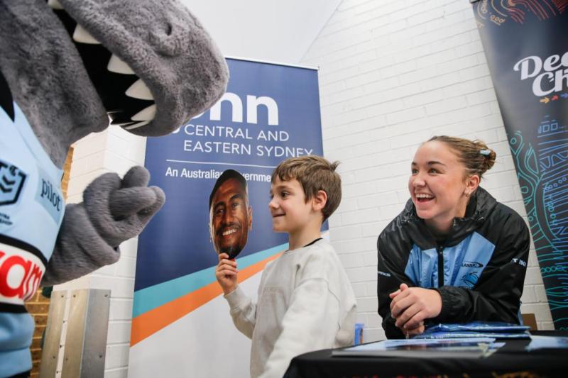 A boy high-fives a mascot