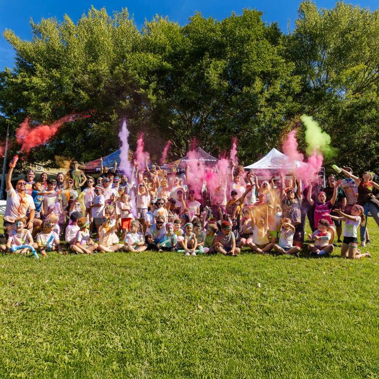 A group of poeple covered in colour after doing the run