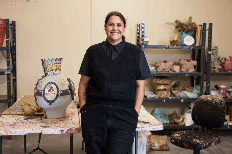 A woman stands in a creative space