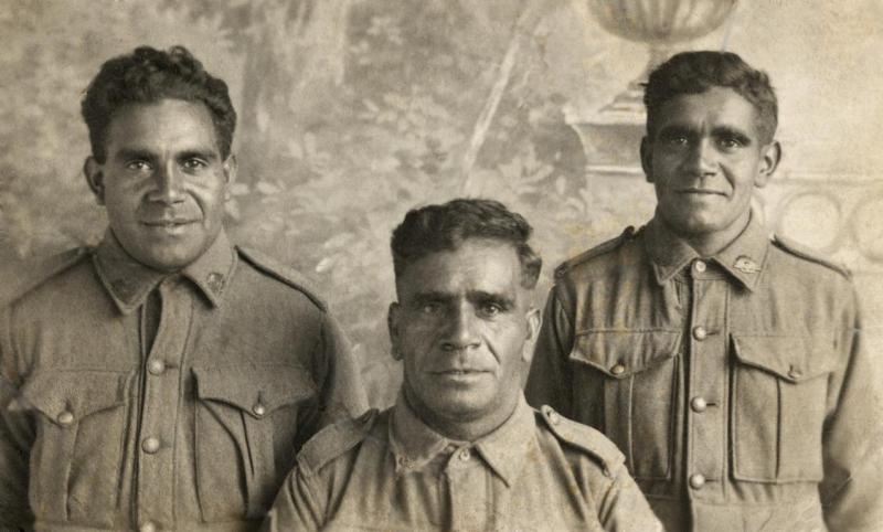 Three men in uniform in an old photo