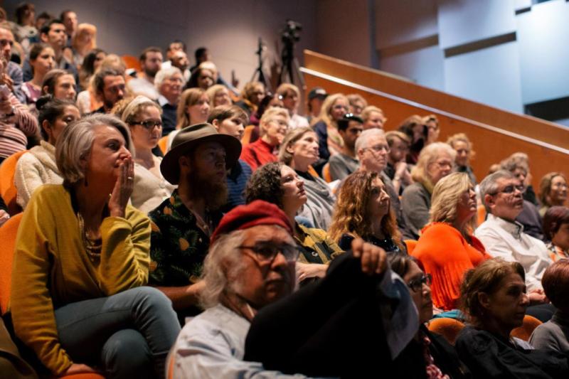 Audiences listening to a talk in a lecture theatre.