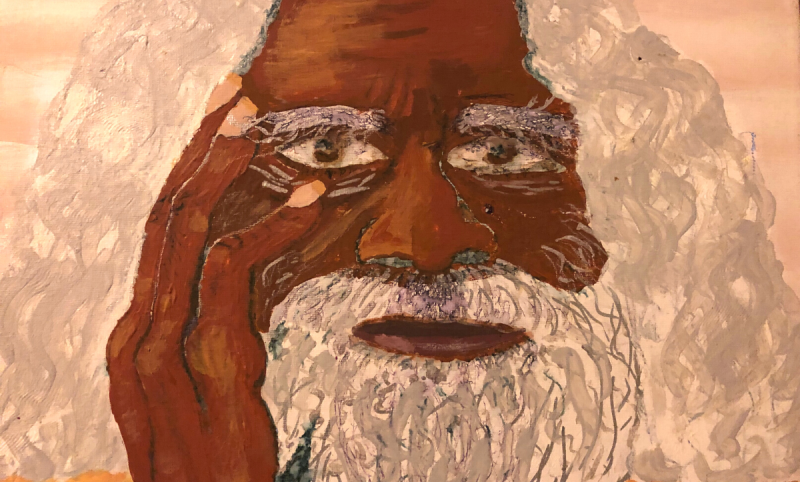 Cropped portrait of an Aboriginal elder Uncle Jack Charles with long white grey hair, dark skin, hand touching his face