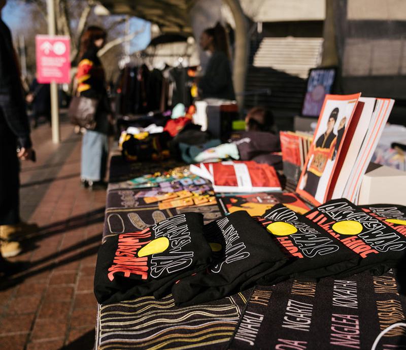 T-shirts displayed on a market stall table